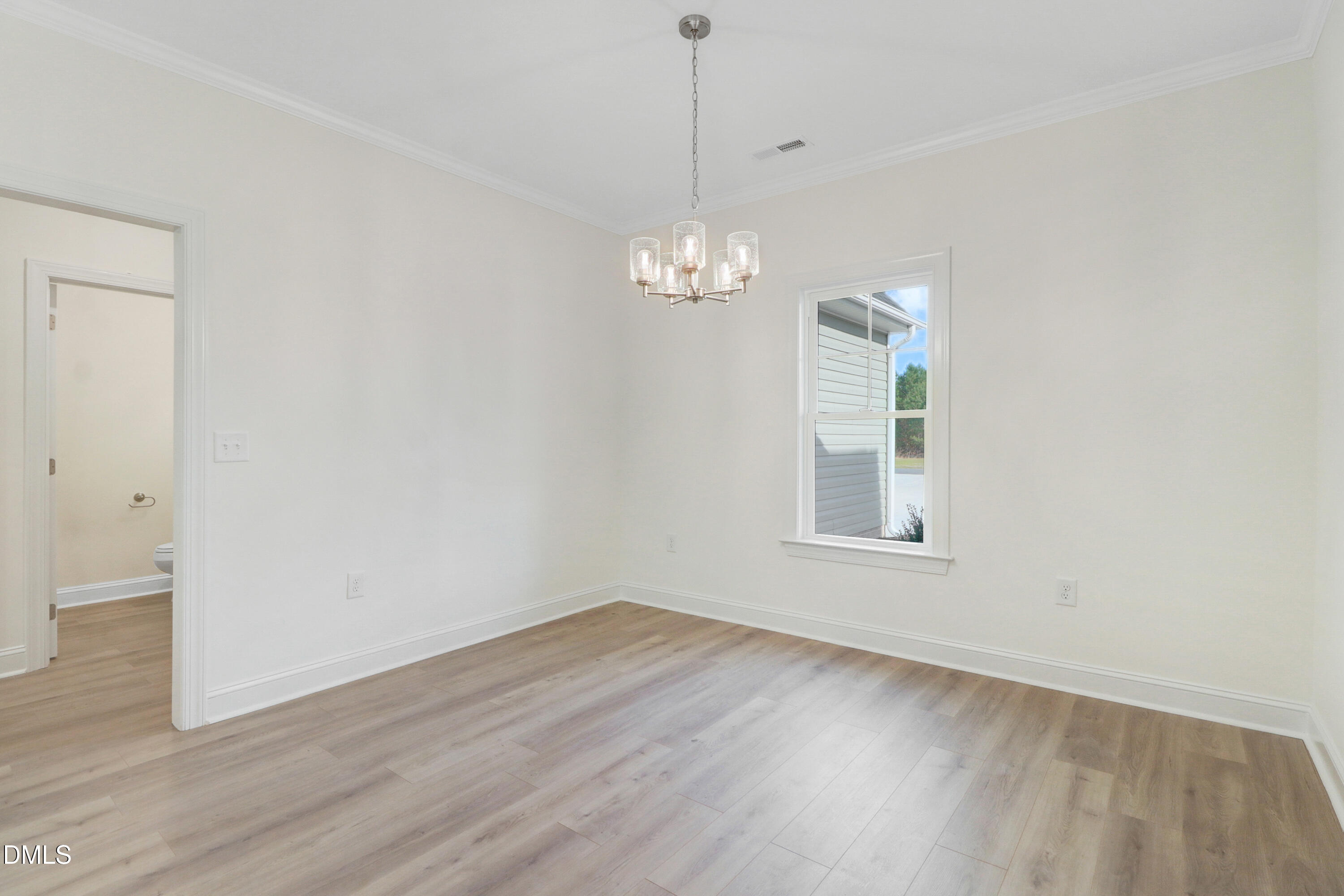110 Rae Drive Pikeville, NC 27863 - Photo 18 of 35 an empty room with wooden floor and windows