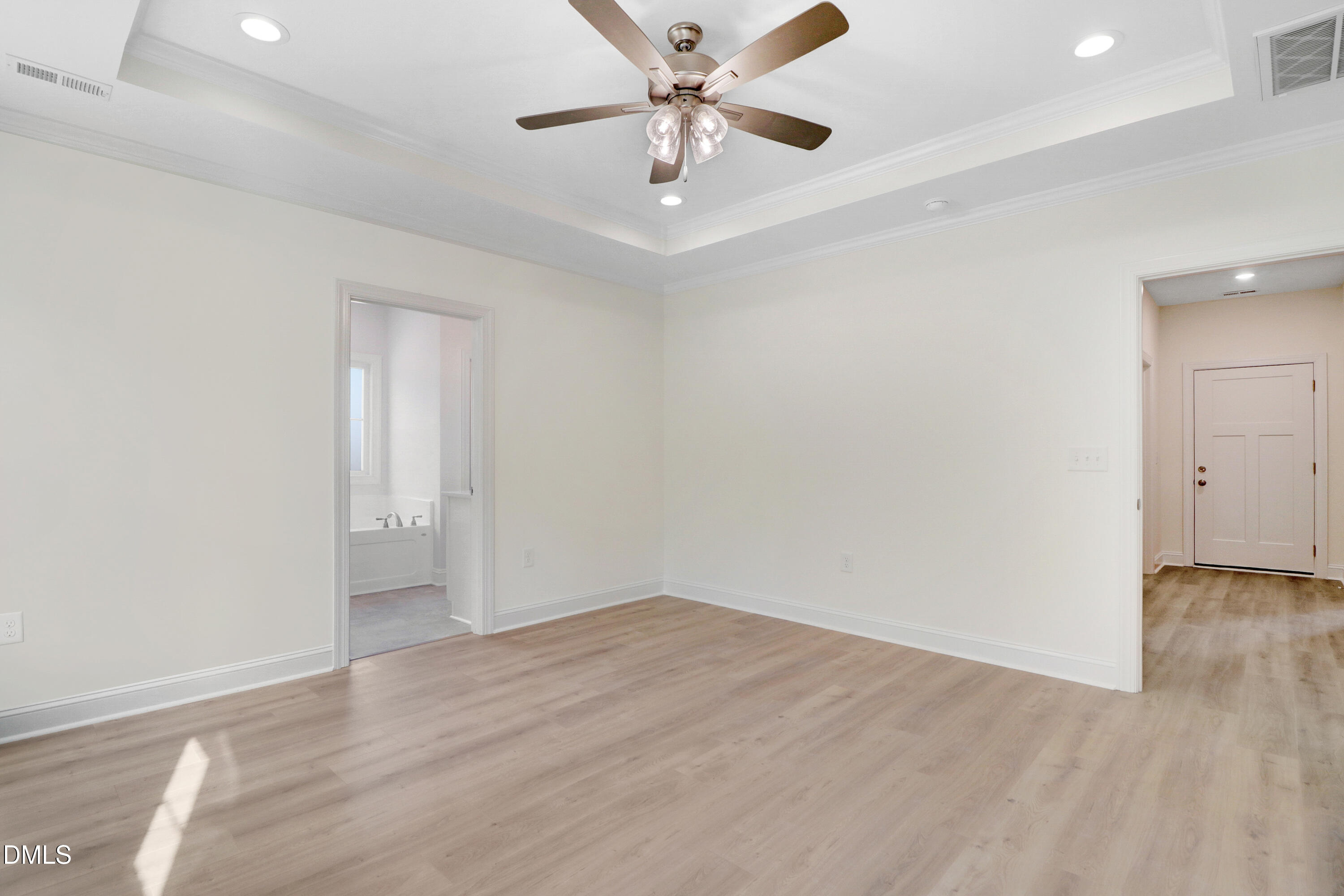 110 Rae Drive Pikeville, NC 27863 - Photo 20 of 35 an empty room with wooden floor and a ceiling fan