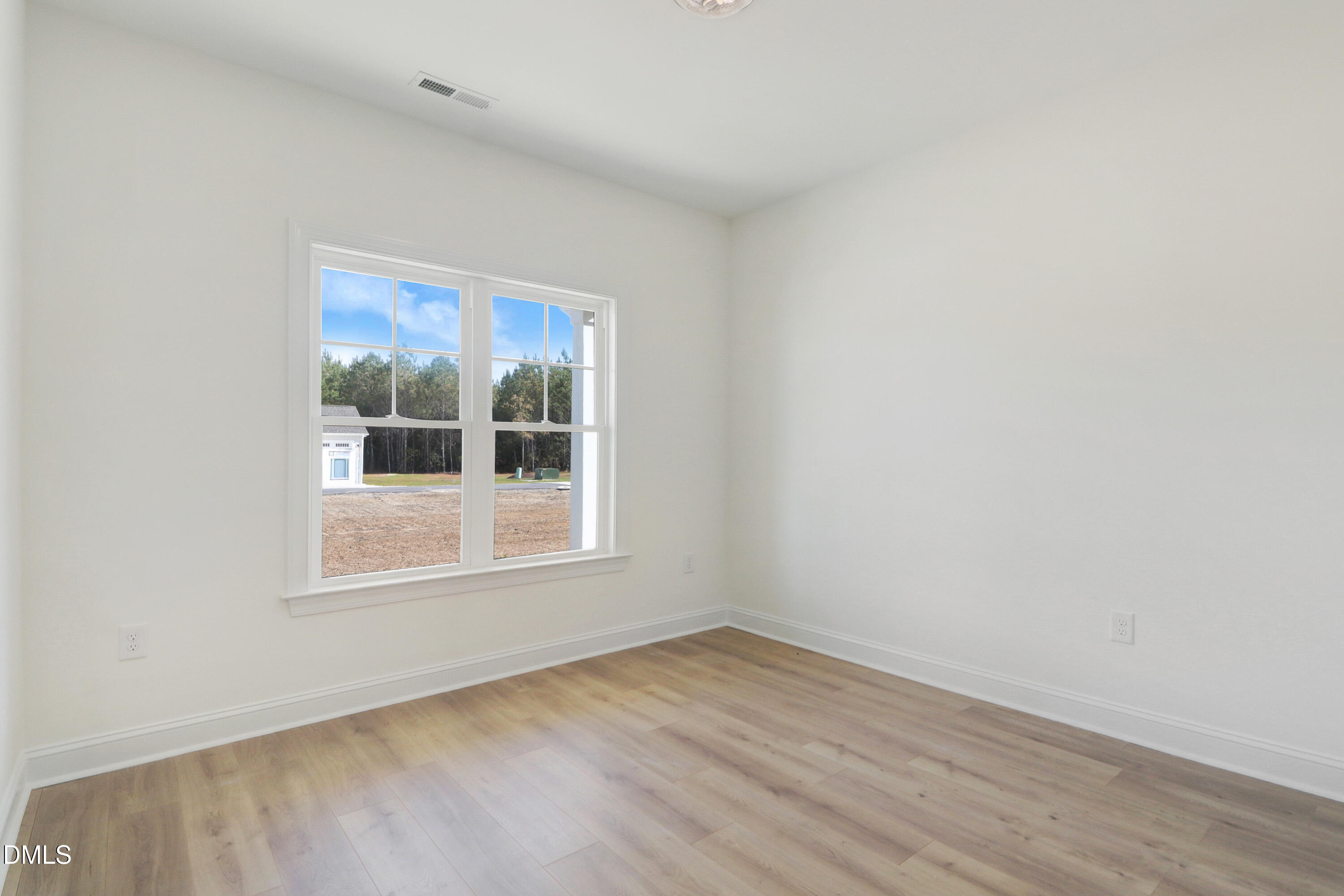 110 Rae Drive Pikeville, NC 27863 - Photo 25 of 35 an empty room with wooden floor and windows