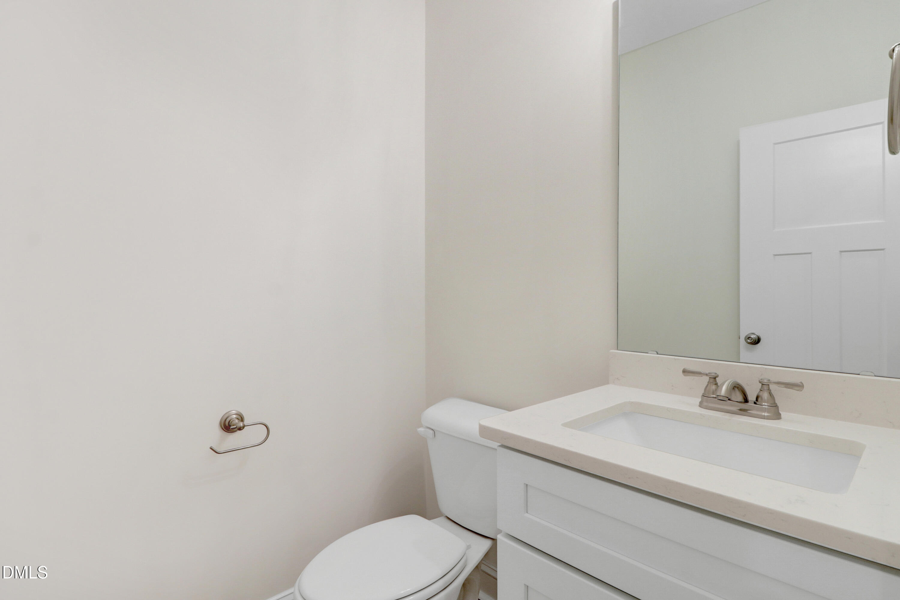 110 Rae Drive Pikeville, NC 27863 - Photo 30 of 35 a bathroom with a toilet sink vanity and mirror