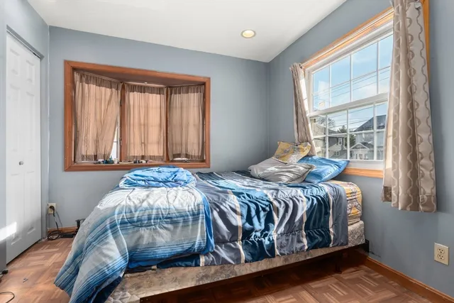 a bedroom with a bed and window