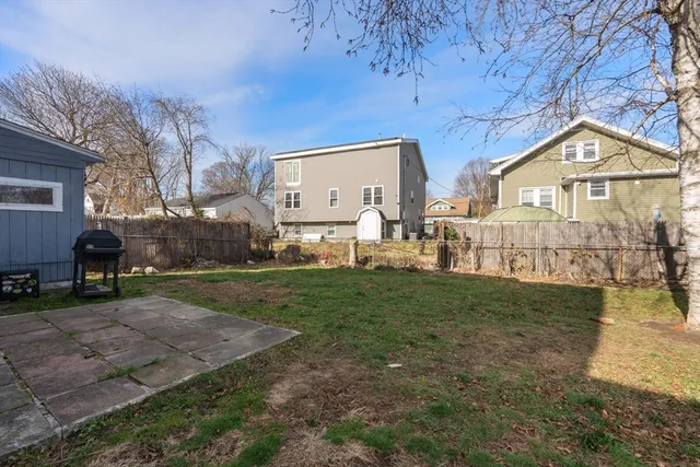 a view of a big house with a big yard and large trees