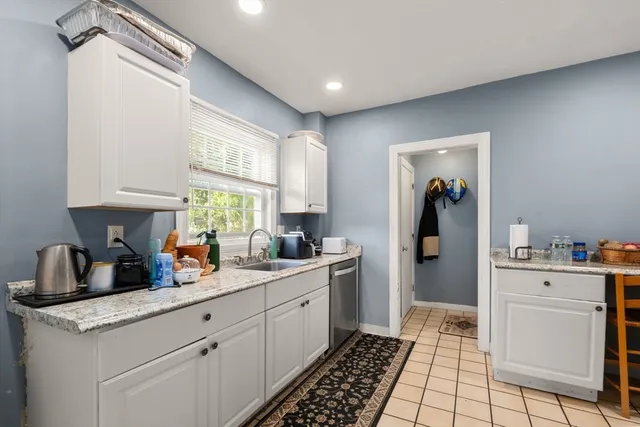 a kitchen with a sink cabinets and window