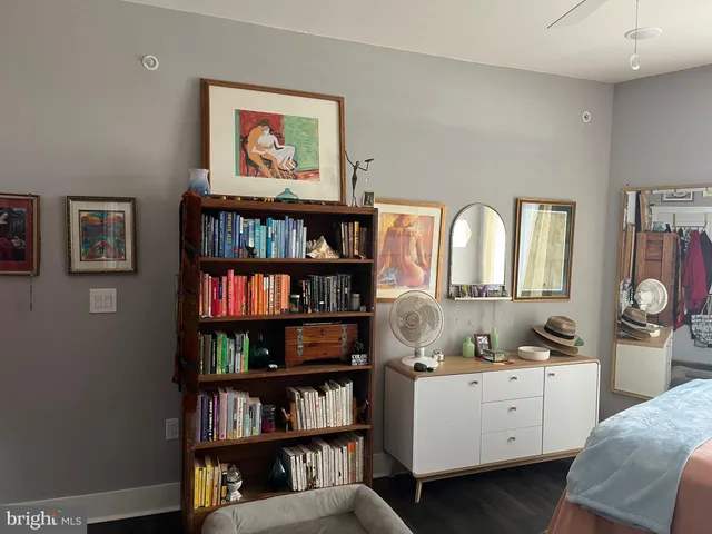 a view of a hallway with paintings on the wall
