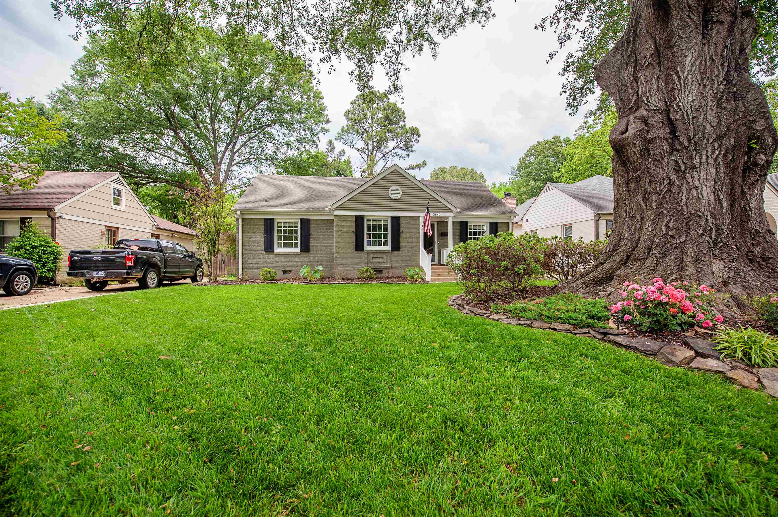 3640 Aurora Circle Memphis, TN 38111 - Photo 3 of 24 a front view of a house with a garden and trees
