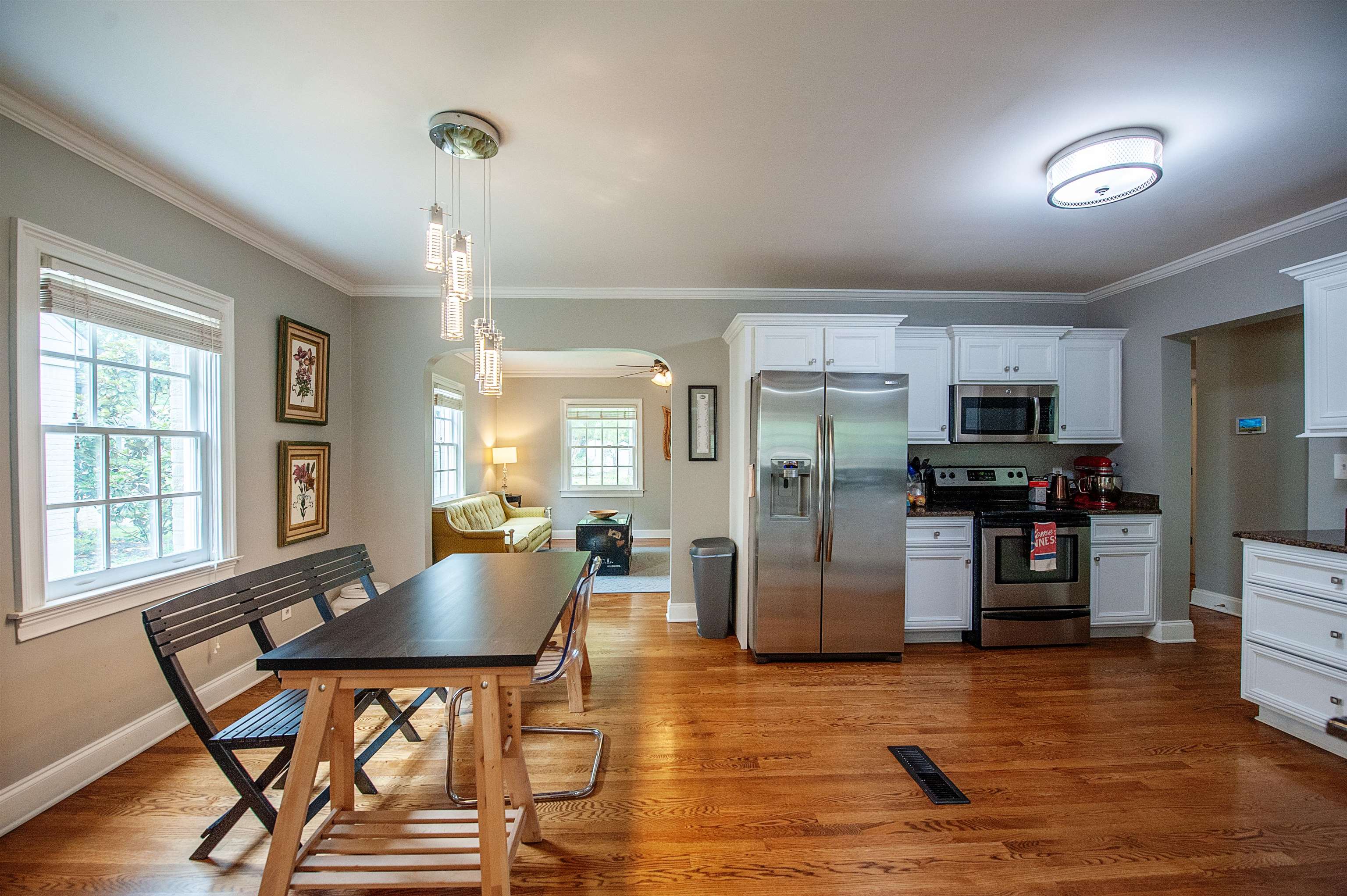 3640 Aurora Circle Memphis, TN 38111 - Photo 7 of 24 a kitchen with stainless steel appliances kitchen island granite countertop a refrigerator a stove top oven and a dining table with wooden floor