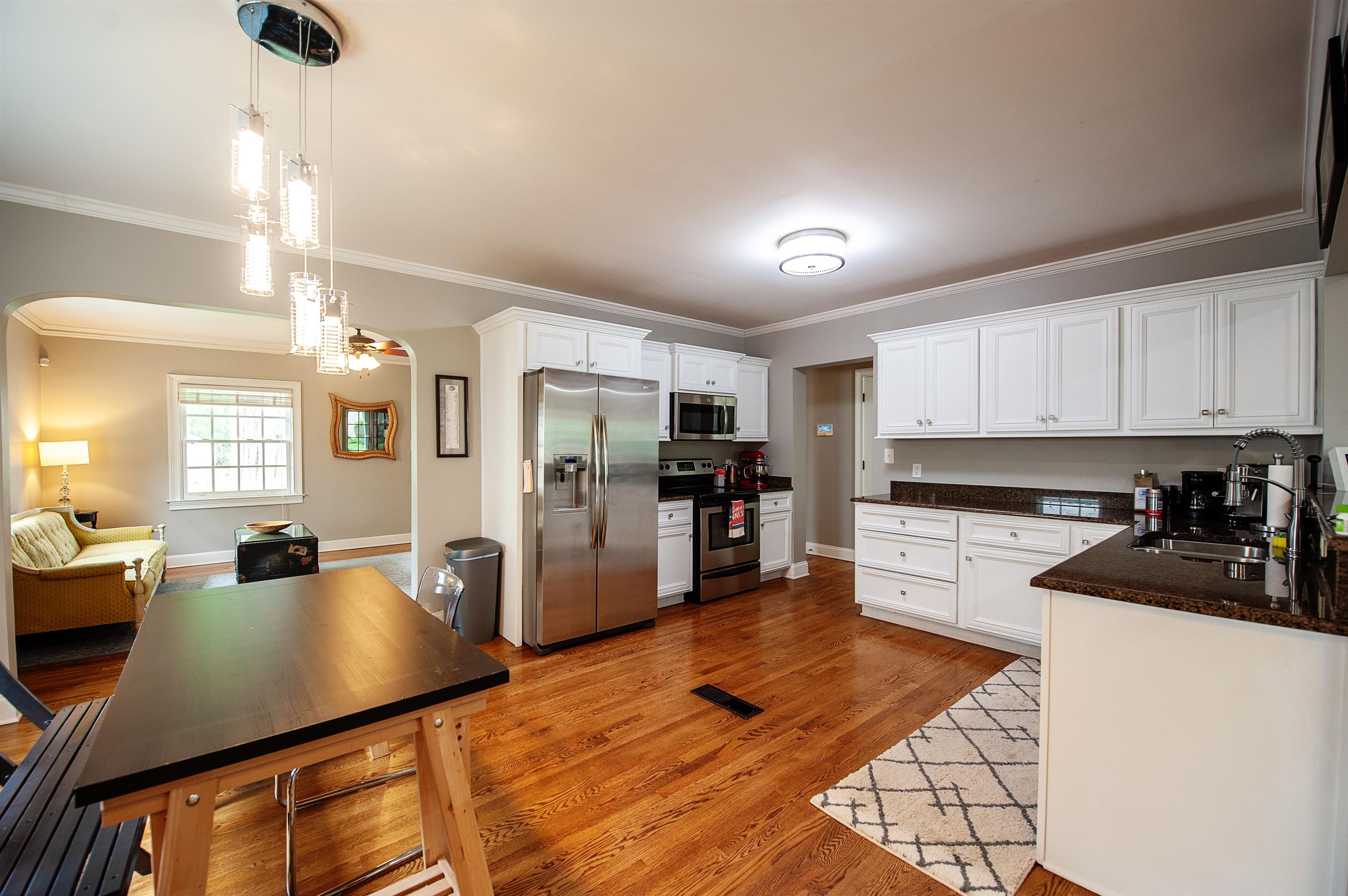 3640 Aurora Circle Memphis, TN 38111 - Photo 9 of 24 a kitchen with stainless steel appliances kitchen island granite countertop a refrigerator a stove a sink dishwasher and white countertops with wooden floor