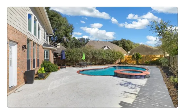 a view of a backyard with plants and a patio
