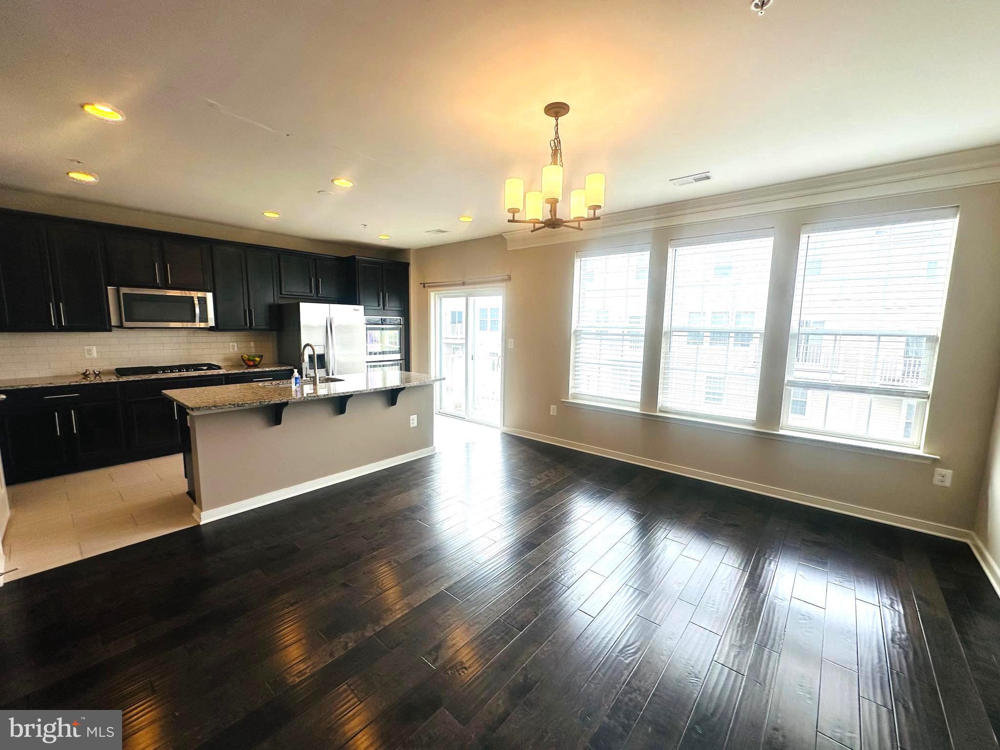 25576 Tolar Square Chantilly, VA 20152 - Photo 12 of 55 a view of a kitchen with wooden floor and a window