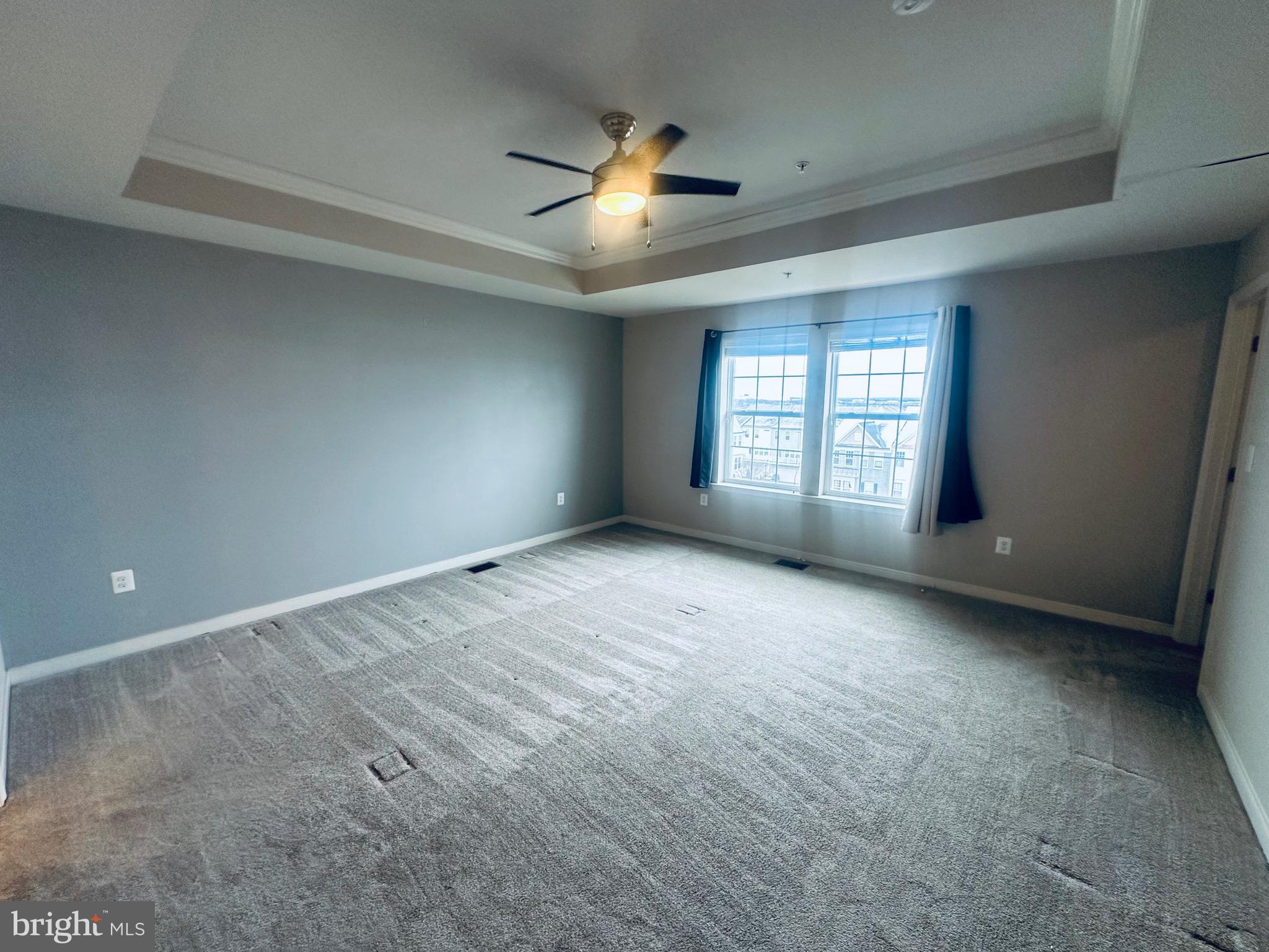 25576 Tolar Square Chantilly, VA 20152 - Photo 26 of 55 an empty room with a chandelier fan and windows
