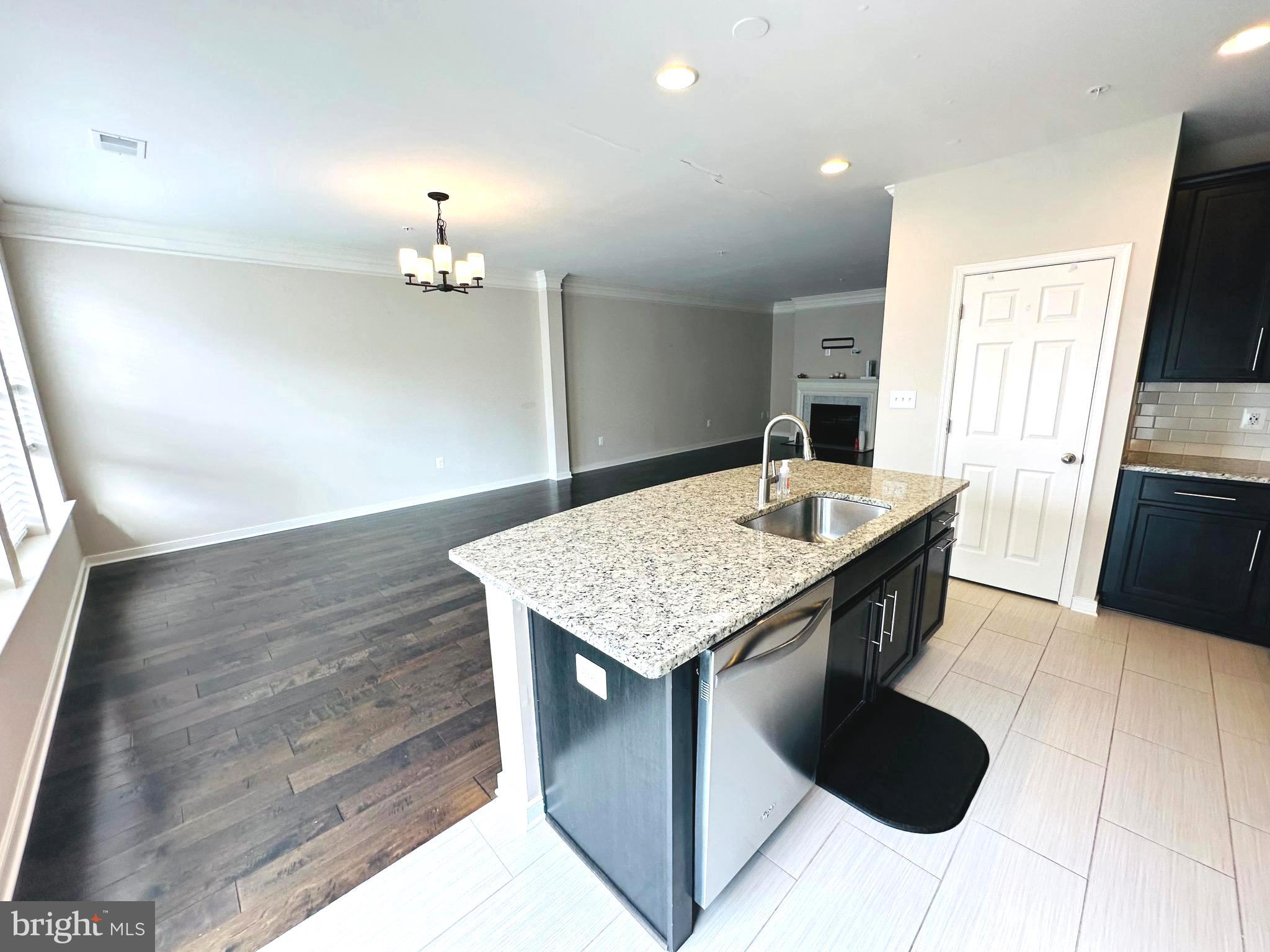 25576 Tolar Square Chantilly, VA 20152 - Photo 4 of 55 a kitchen with a table chairs in it and wooden floors