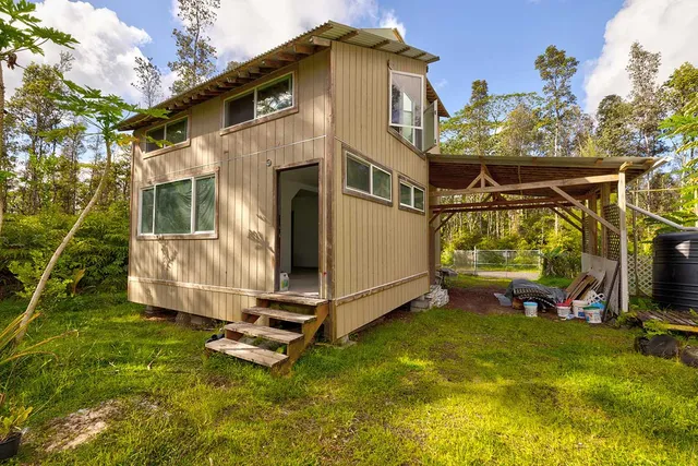 a view of a small house with a yard