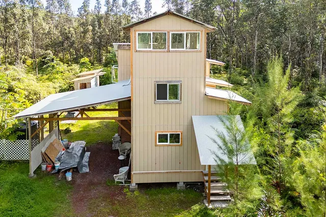 a view of a house with backyard sitting area and garden