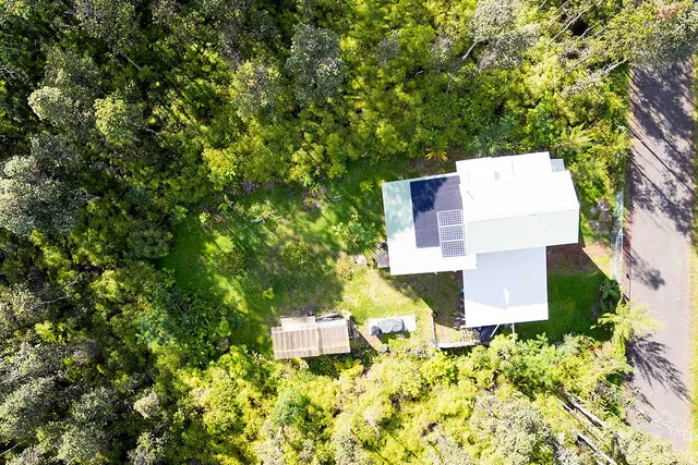 view of a house with a yard and sitting area