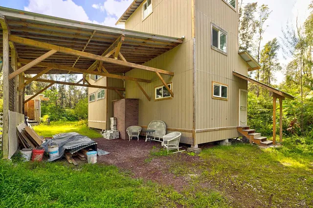 a view of a backyard with table and chairs