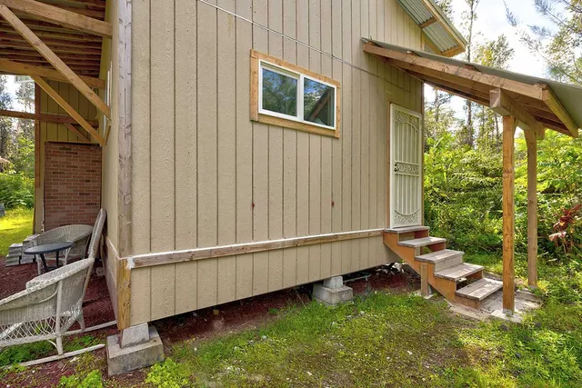 a backyard with hardwood wall table and chairs
