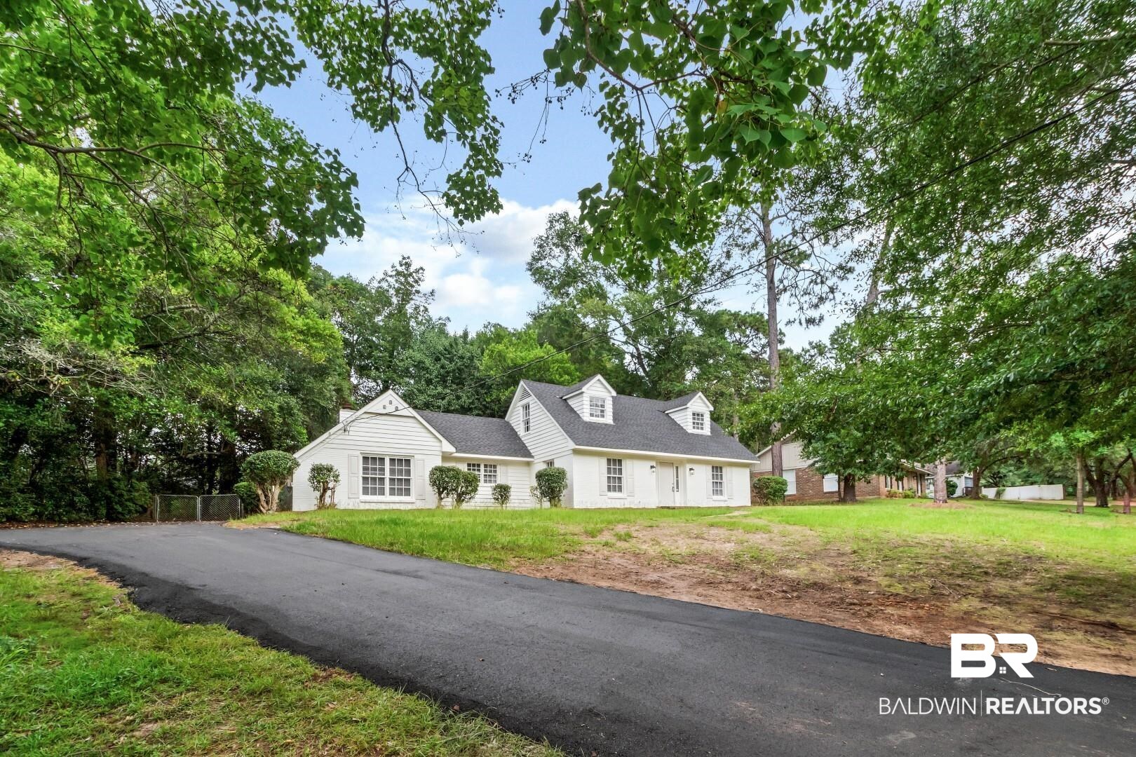 810 Nassau Drive Mobile, AL 36608 - Photo 26 of 31 Cape cod house featuring a front lawn and view of wooded area