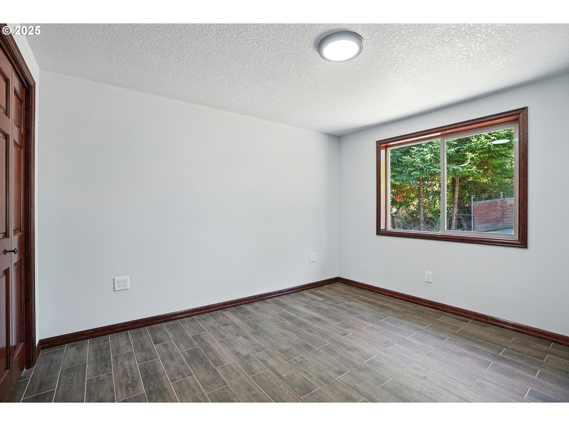 70292 Walker Road Rainier, OR 97048 - Photo 16 of 40 an empty room with wooden floor and windows
