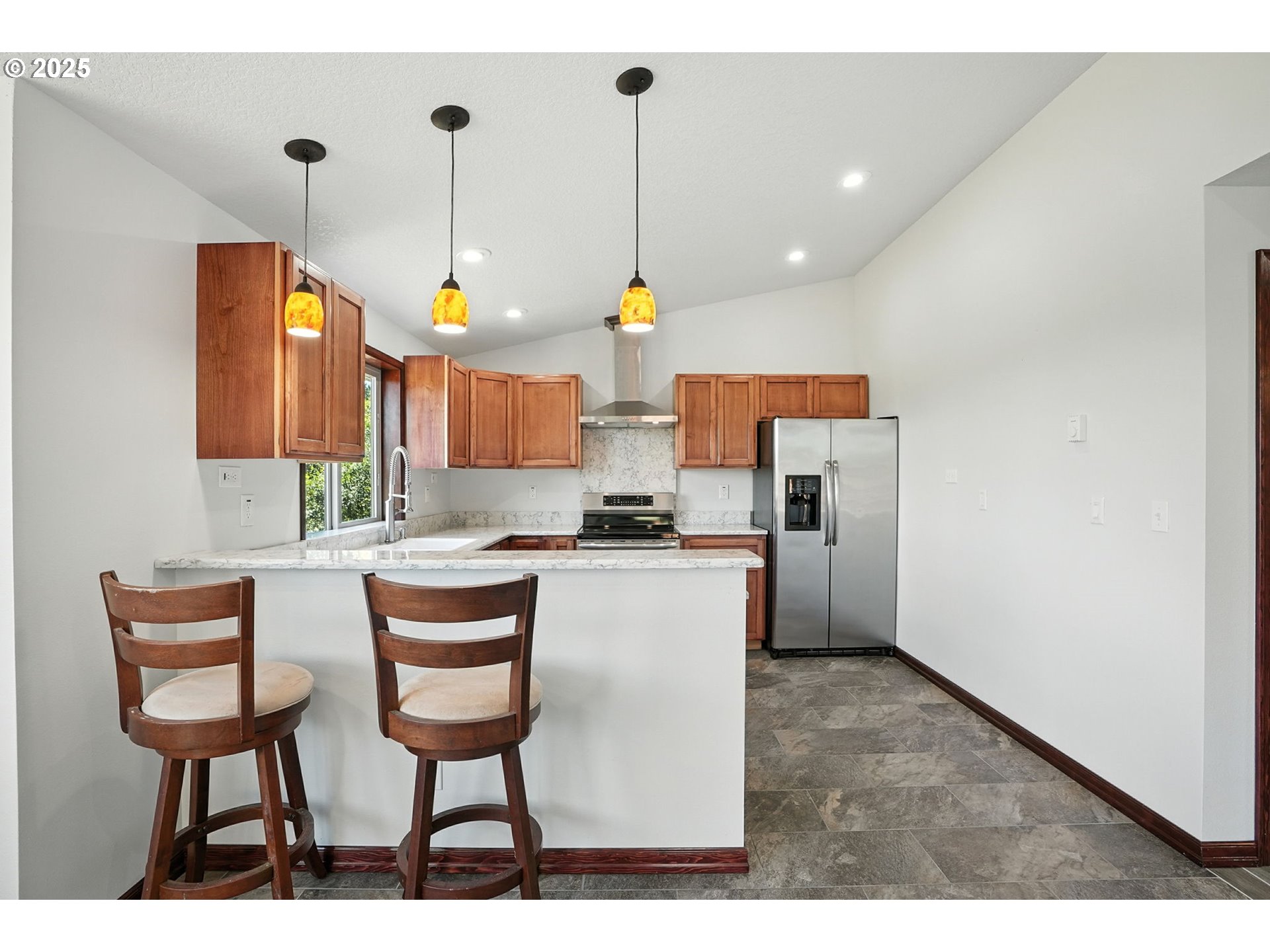 70292 Walker Road Rainier, OR 97048 - Photo 5 of 40 a kitchen with a refrigerator a sink dishwasher a dining table and chairs
