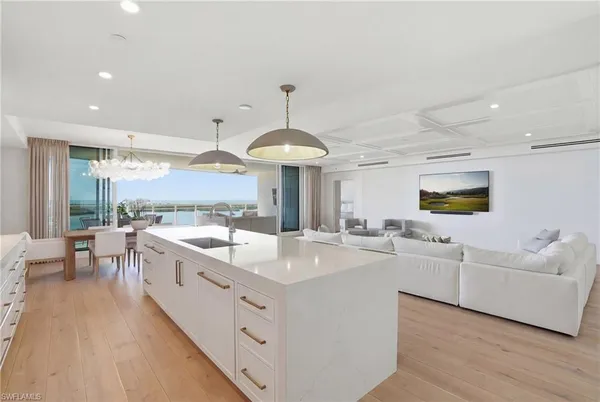 a large white kitchen with a large window
