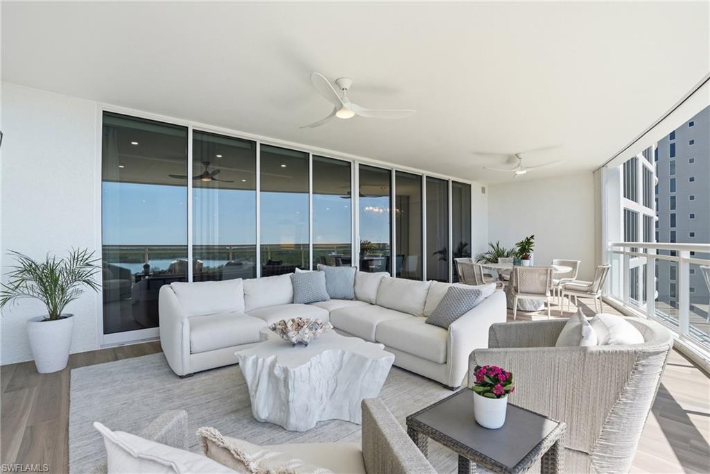 13945 Old Coast Road, Unit 803 Naples, FL 34110 - Photo 12 of 37 a living room with furniture and a large window
