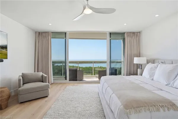 a bedroom with a large bed and a large window
