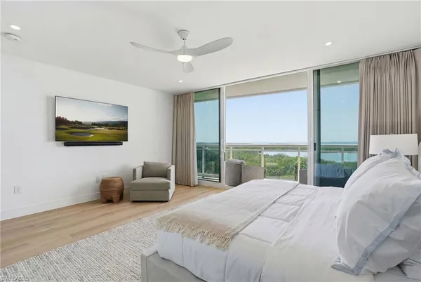 a bedroom with a large bed and a large window