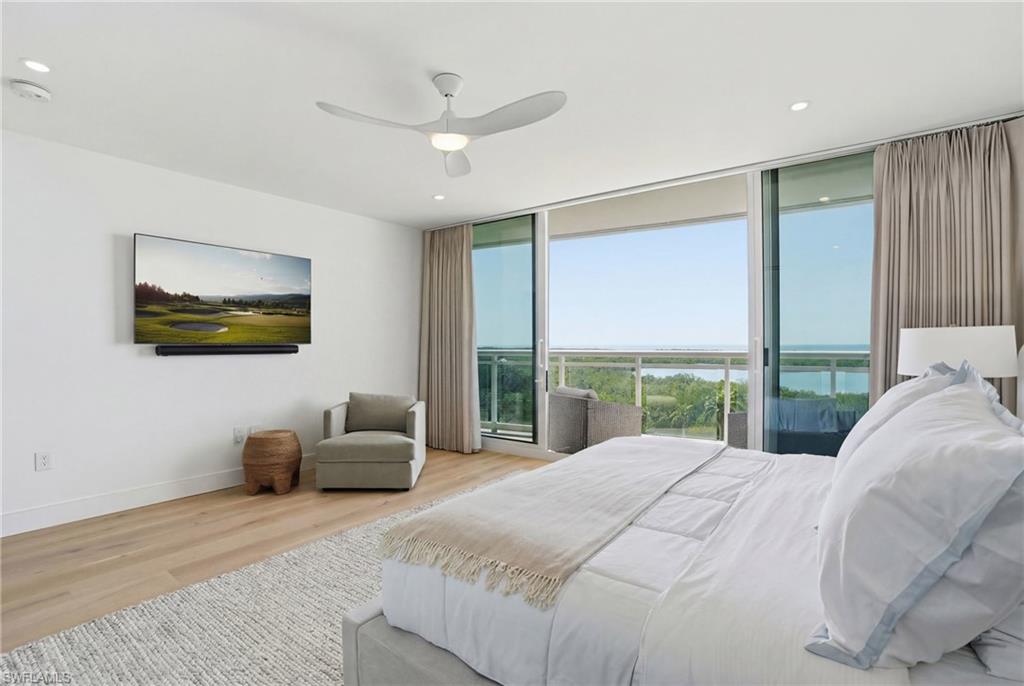13945 Old Coast Road, Unit 803 Naples, FL 34110 - Photo 14 of 37 a bedroom with a large bed and a large window