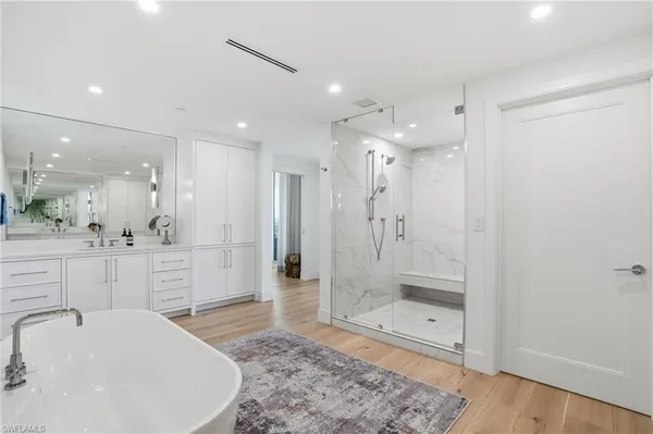 a bathroom with a shower a sink and a mirror