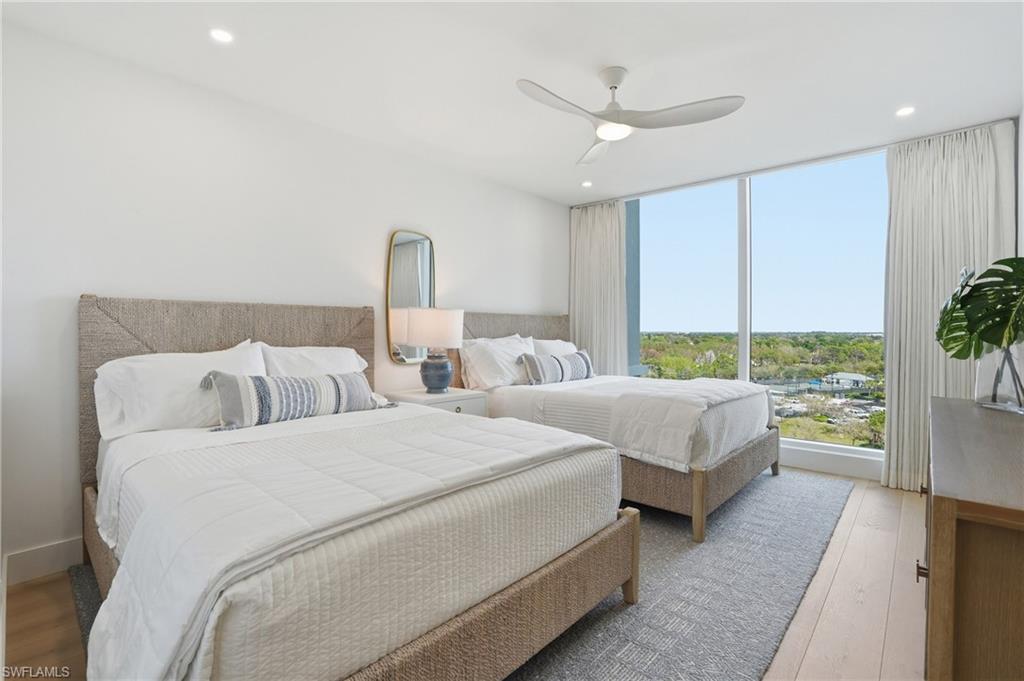 13945 Old Coast Road, Unit 803 Naples, FL 34110 - Photo 17 of 37 a bed room with two bed and a large window