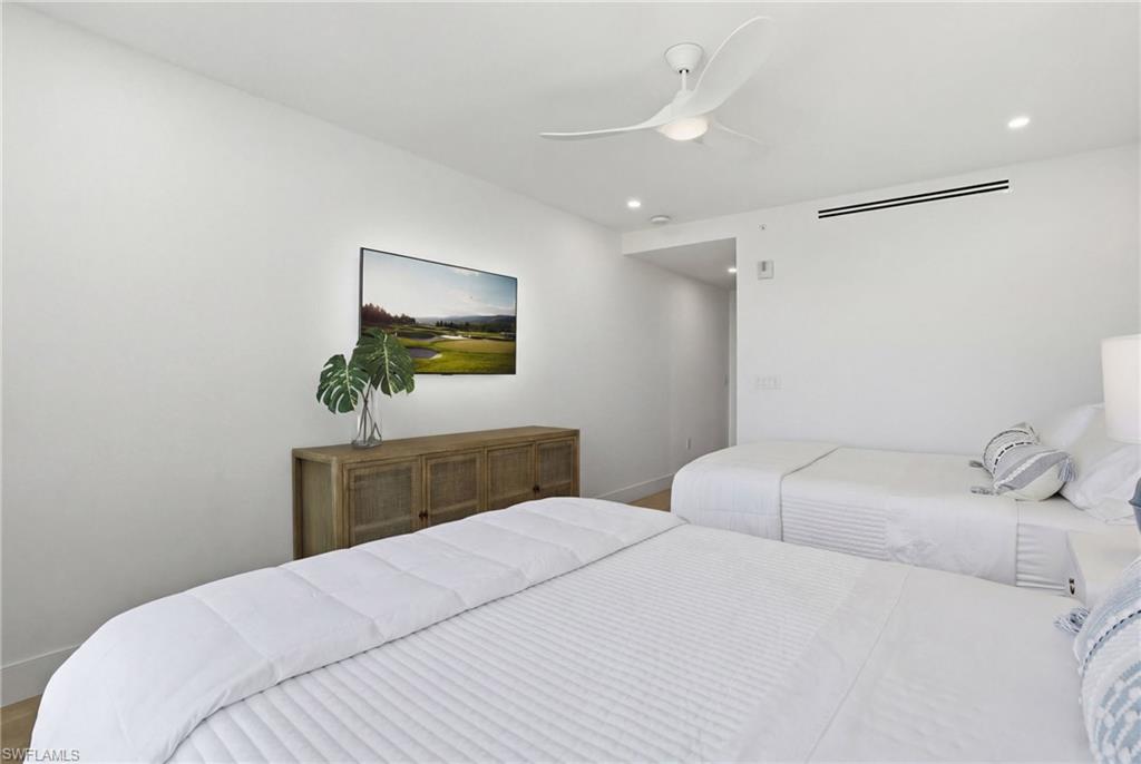 13945 Old Coast Road, Unit 803 Naples, FL 34110 - Photo 18 of 37 a bedroom with a bed and a dresser