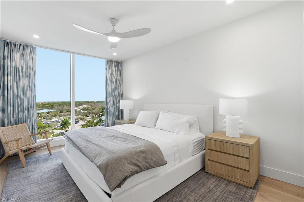 13945 Old Coast Road, Unit 803 Naples, FL 34110 - Photo 22 of 37 a bedroom with a large bed and a window