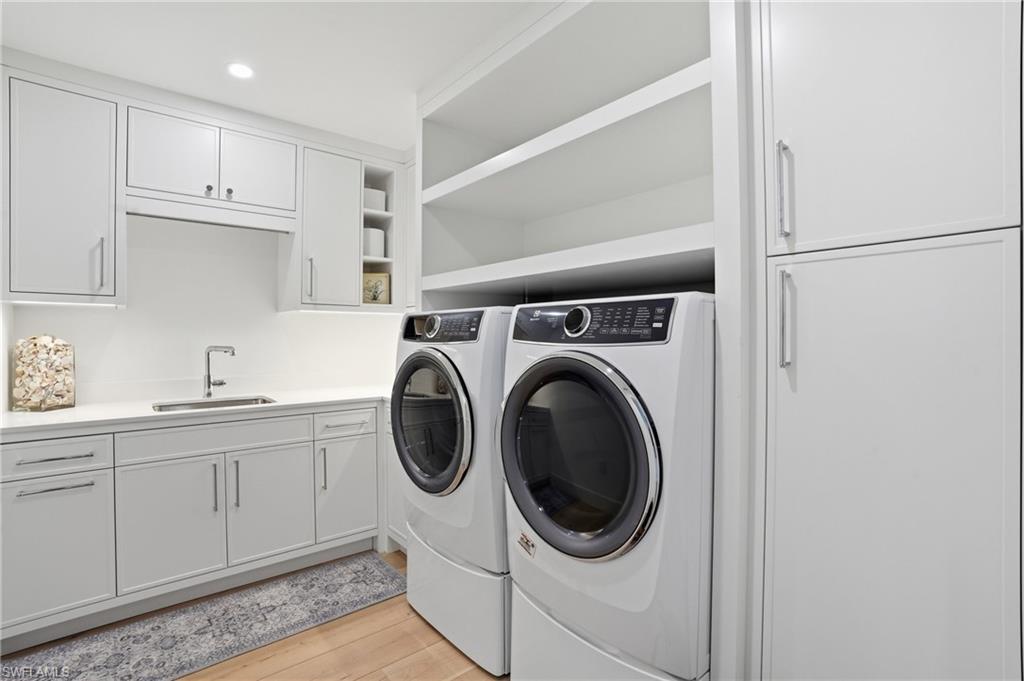 13945 Old Coast Road, Unit 803 Naples, FL 34110 - Photo 24 of 37 a utility room with sink dryer and washer