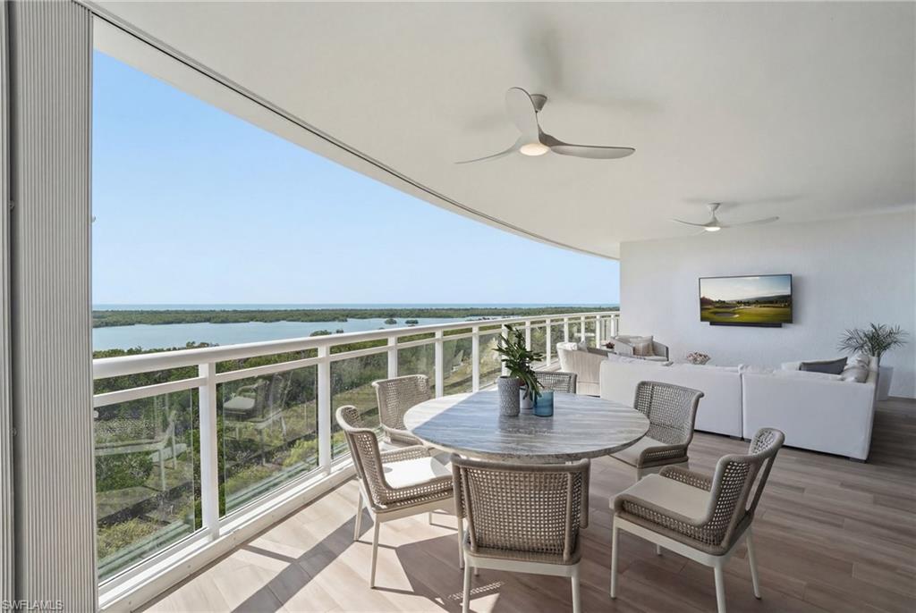 13945 Old Coast Road, Unit 803 Naples, FL 34110 - Photo 25 of 37 a view of a dining room with furniture and chandelier