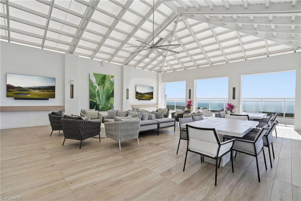 13945 Old Coast Road, Unit 803 Naples, FL 34110 - Photo 29 of 37 a living room with furniture and a wooden floor