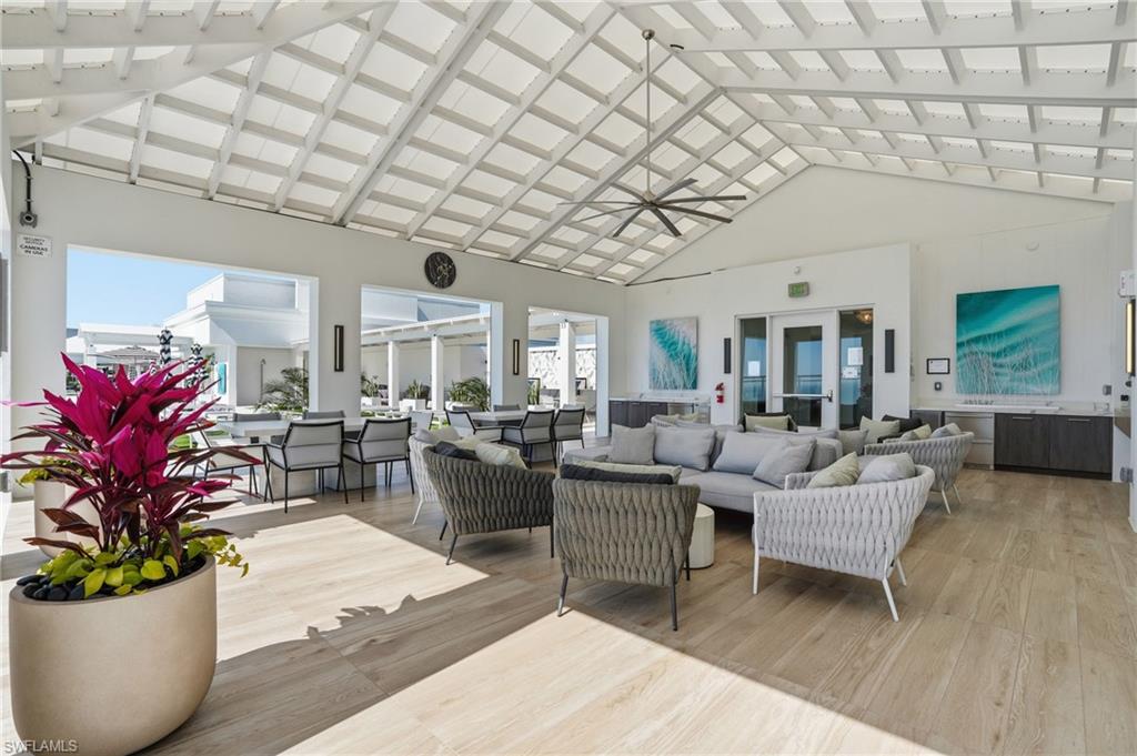 13945 Old Coast Road, Unit 803 Naples, FL 34110 - Photo 30 of 37 a living room with furniture and a potted plant