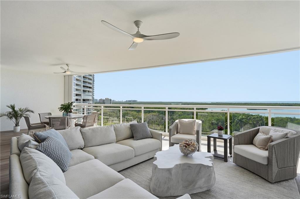 13945 Old Coast Road, Unit 803 Naples, FL 34110 - Photo 3 of 37 a living room with furniture and a large window