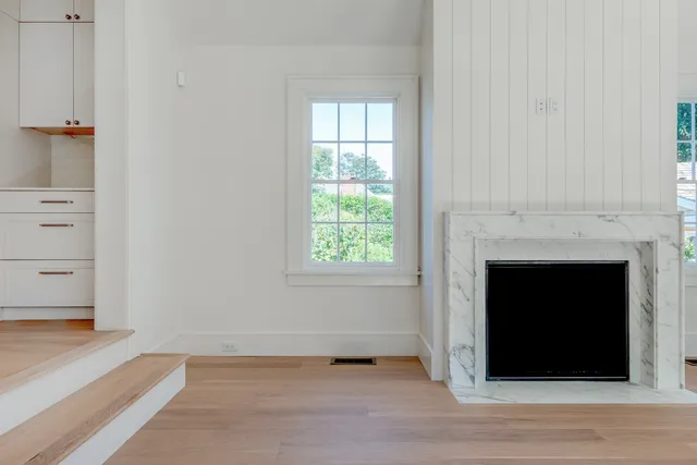 a view of staircase with wooden floor and white walls