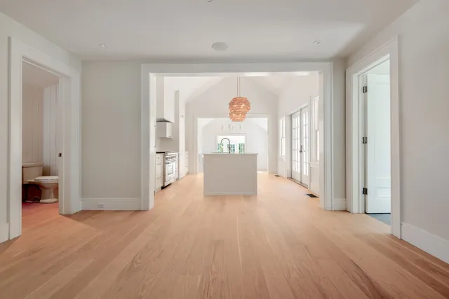 a view of empty room with wooden floor and fireplace