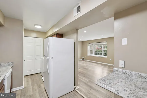 a view of hallway with wooden floor and staircase