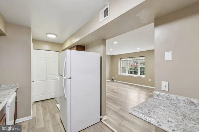 a view of hallway with wooden floor and staircase