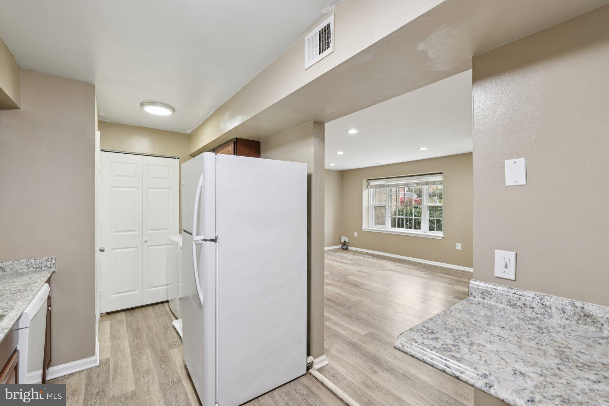 9075 North Laurel Road, Unit E Laurel, MD 20723 - Photo 14 of 28 a view of hallway with wooden floor and staircase