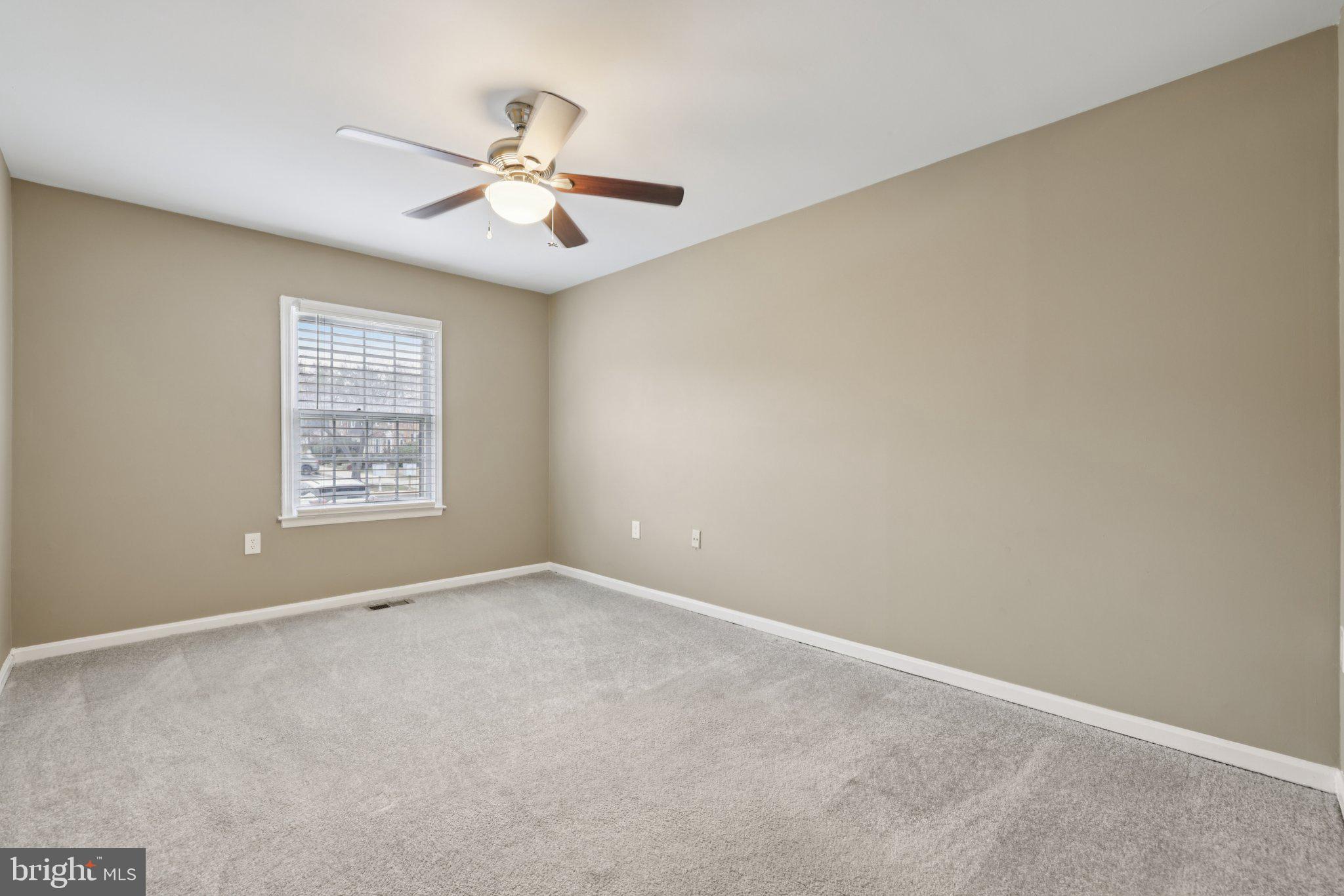 9075 North Laurel Road, Unit E Laurel, MD 20723 - Photo 19 of 28 an empty room with windows and fan