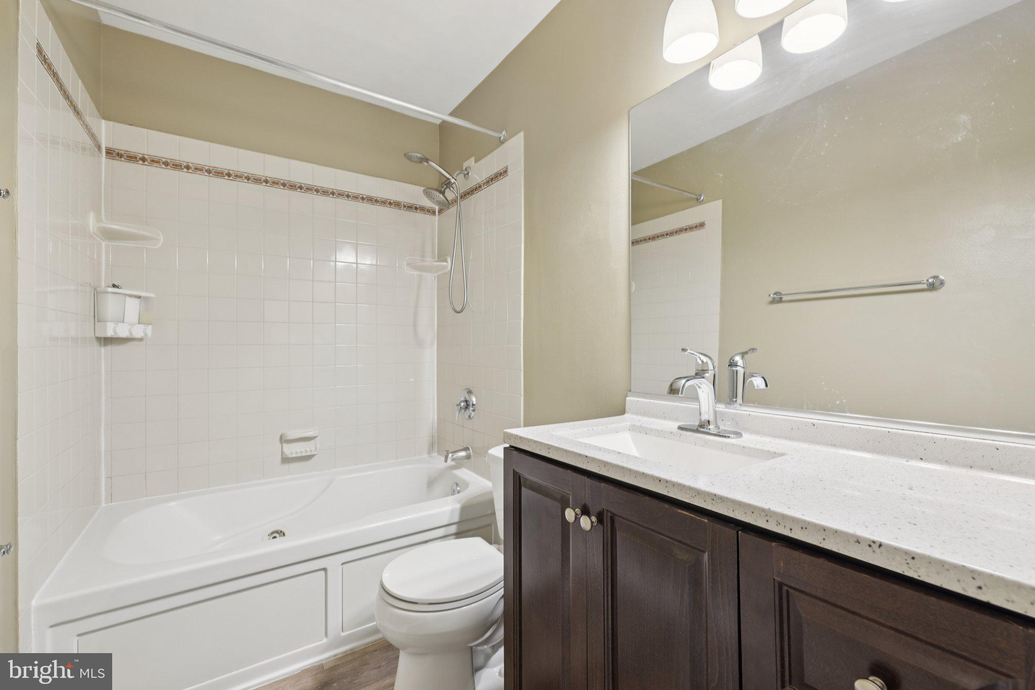 9075 North Laurel Road, Unit E Laurel, MD 20723 - Photo 24 of 28 a bathroom with a sink a toilet and shower