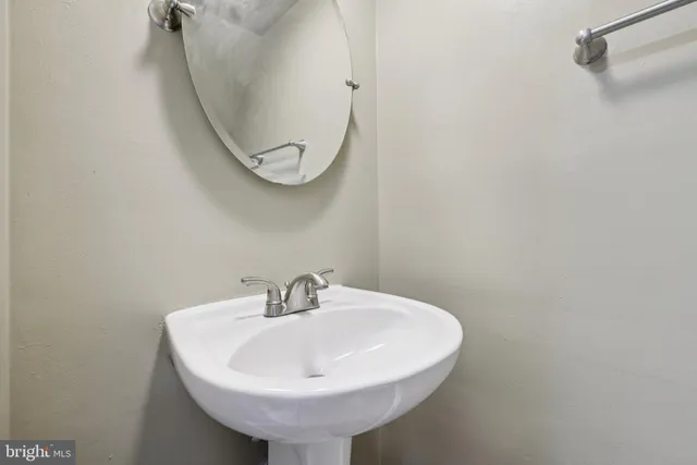 a bathroom with a sink and mirror