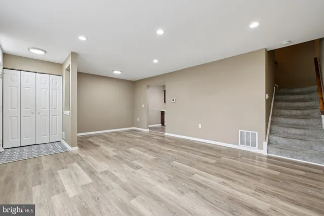 a view of empty room with wooden floor