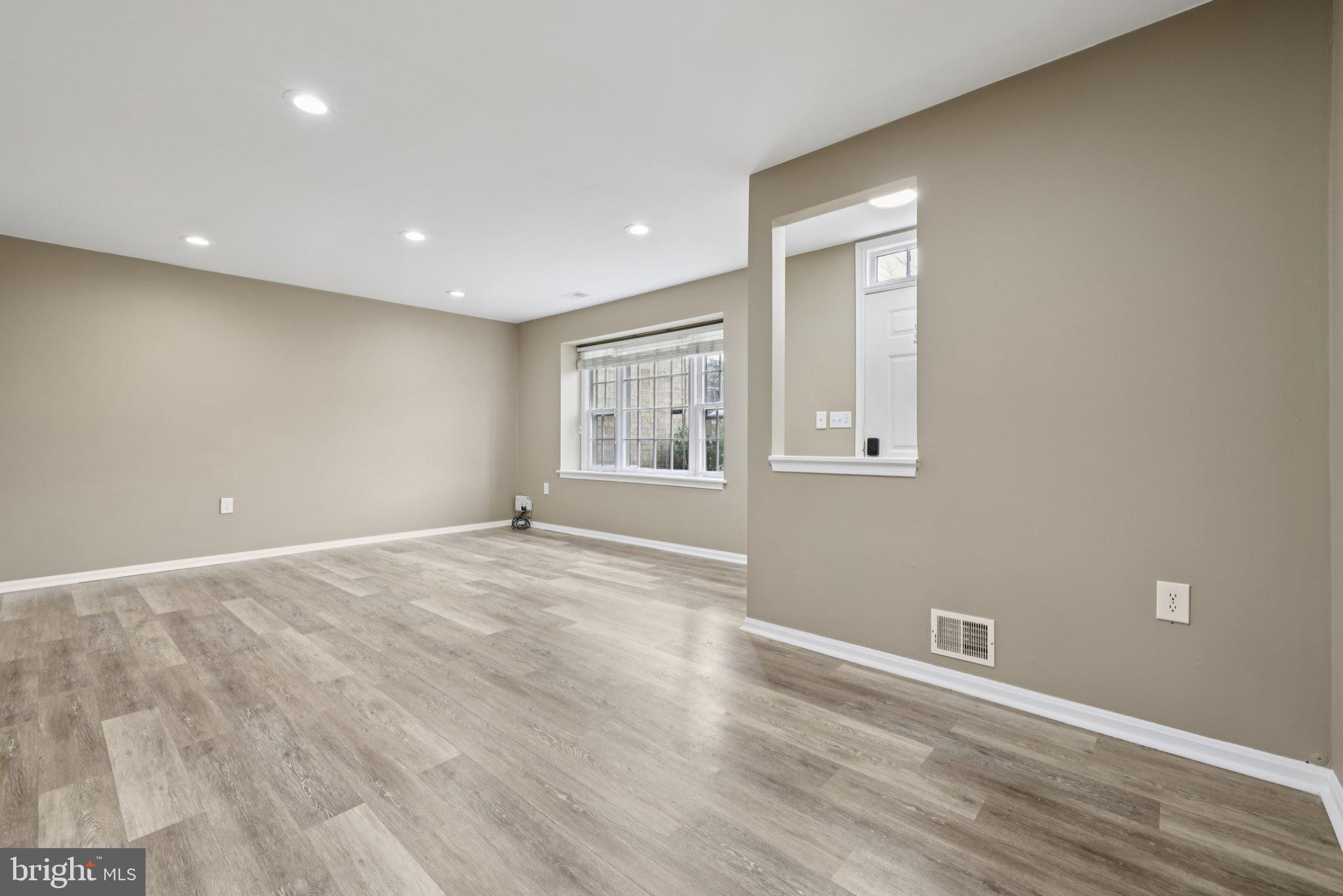 9075 North Laurel Road, Unit E Laurel, MD 20723 - Photo 10 of 28 an empty room with wooden floor and windows