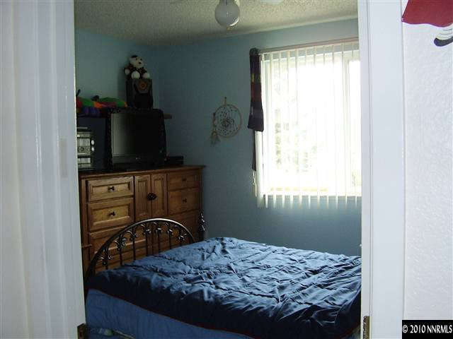 3415 Canvasback Lane Reno, NV 89508 - Photo 3 of 3 a bedroom with a bed and flat screen tv