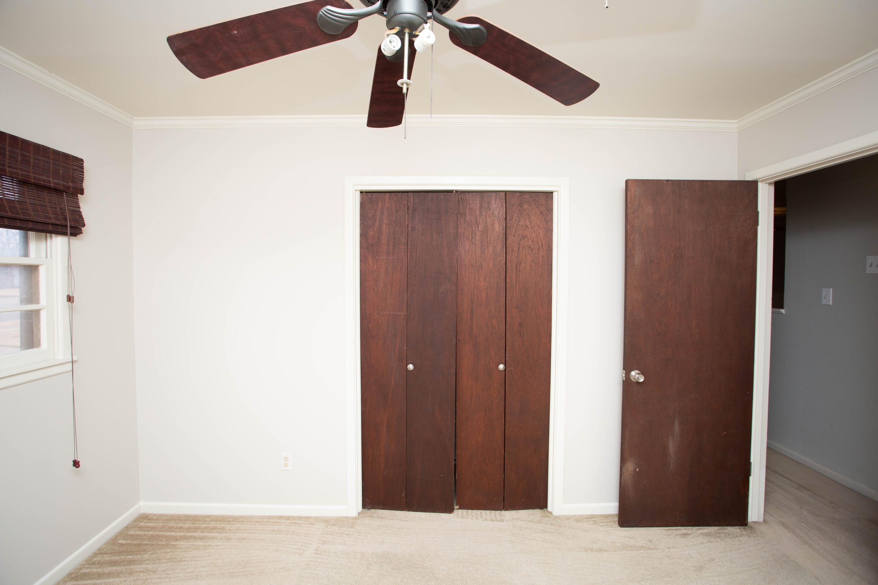 4932 9th Street Lubbock, TX 79416 - Photo 13 of 29 a bedroom with a bed and a chandelier fan