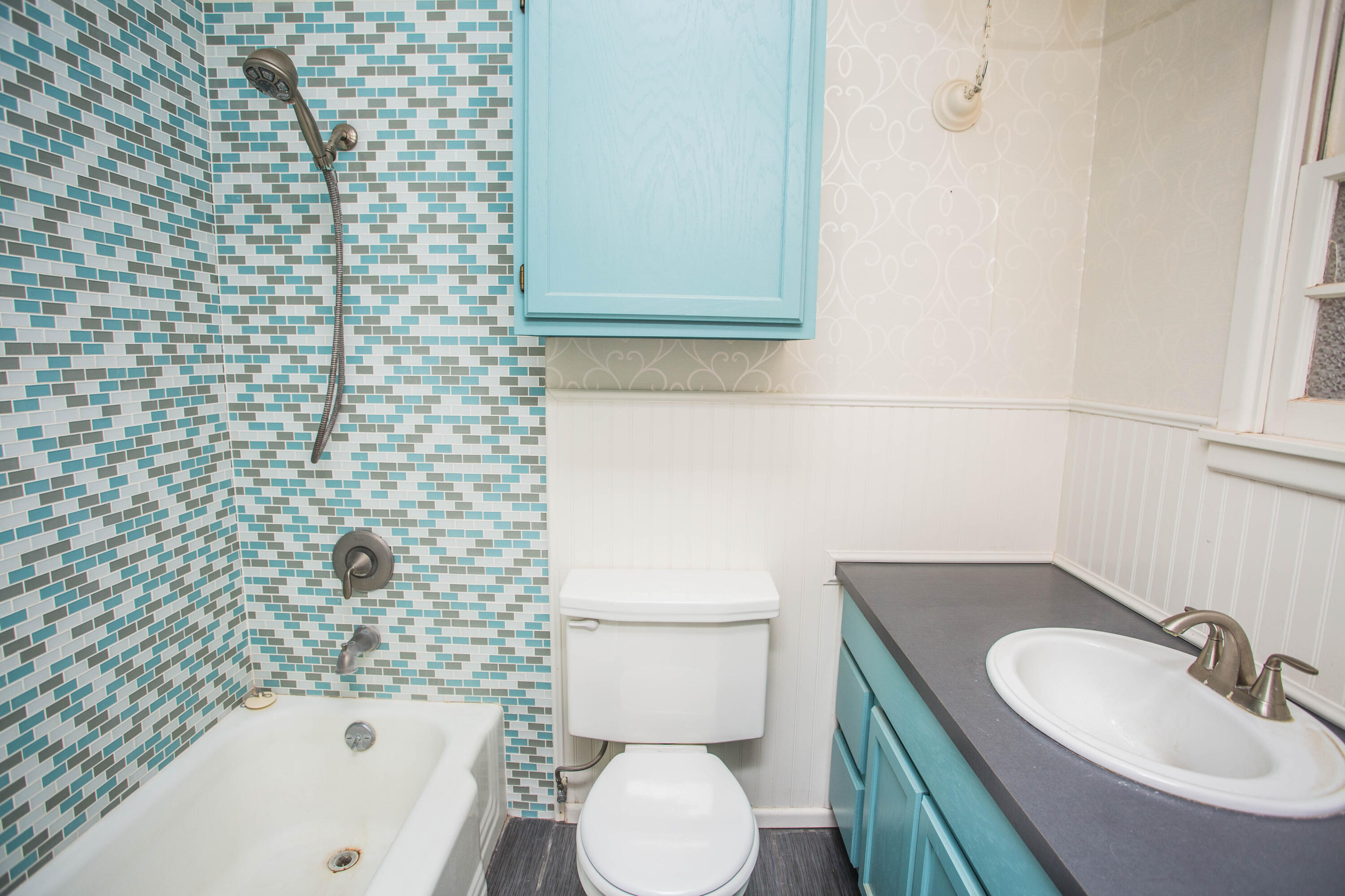 4932 9th Street Lubbock, TX 79416 - Photo 20 of 29 a bathroom with a sink a toilet and bathtub